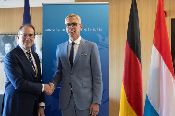 Alexander Dobrindt shaking hands with Luxembourg’s interior minister Léon Gloden in front of German and Luxembourg flags