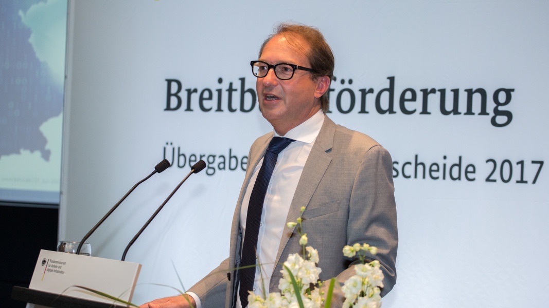 Alexander Dobrindt at a lectern in front of a Breitbandförderung banner